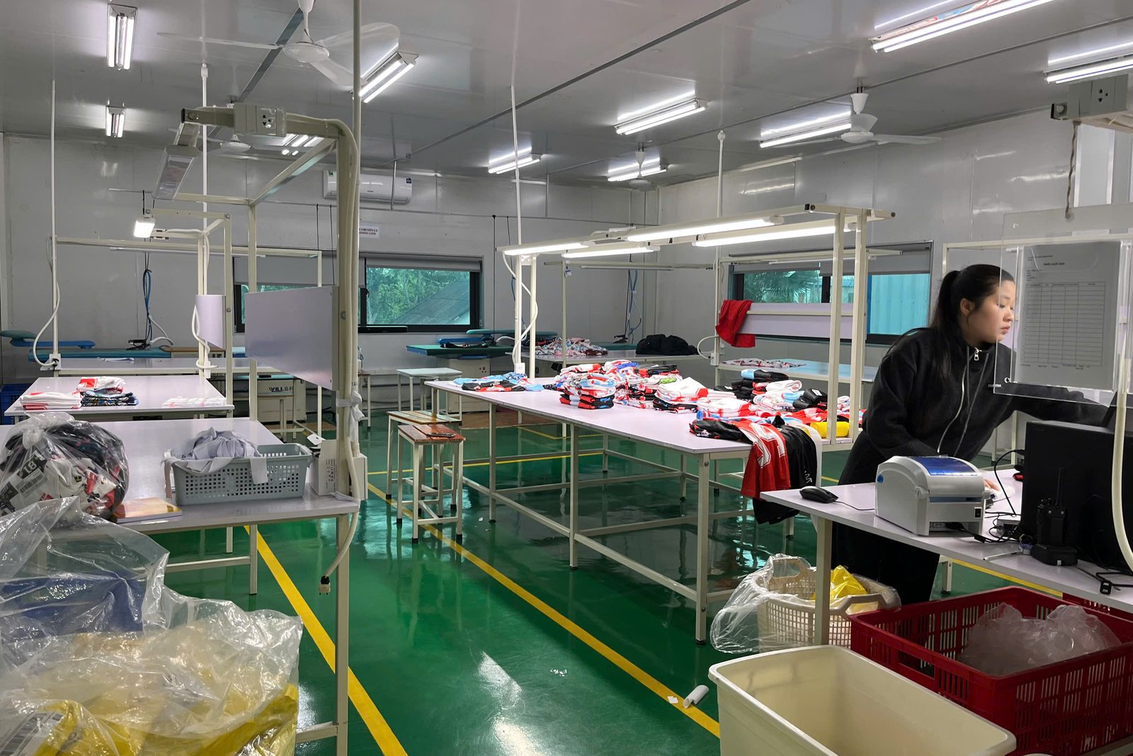 Bulk apparel manufacturing floor at Onospod Vietnam factory with workers processing orders