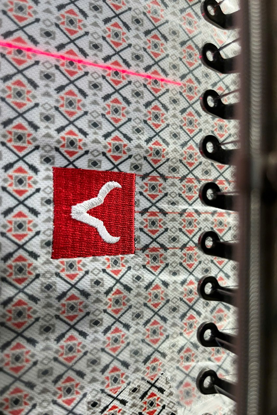 Custom Jersey Manufacturer 12 Close-up embroidery process on jersey fabric