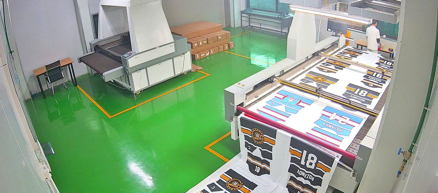 Onospod all-over print sublimation production room — jerseys on cutting conveyor, Hanoi Vietnam
